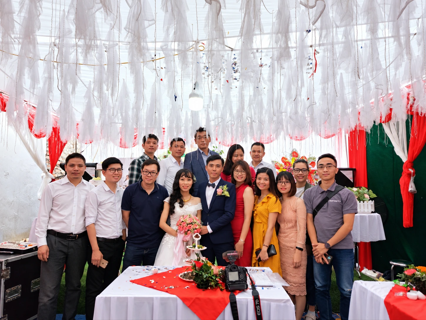 Colleagues posing with the bride and groom on their wedding day